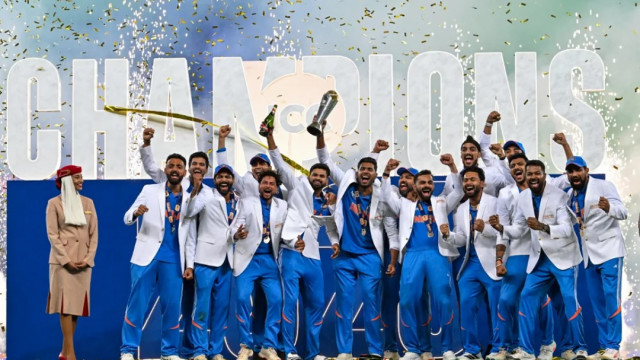 India's players celebrate with the trophy after winning the ICC Champions Trophy one-day international (ODI) final cricket match against New Zealand at the Dubai International Stadium in Dubai on Sunday (photo: AFP)