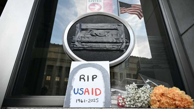 File image: Tributes are placed beneath the covered seal of the US Agency for International Development (USAID) at their headquarters in Washington, DC, on February 7, 2025. Photo: AFP