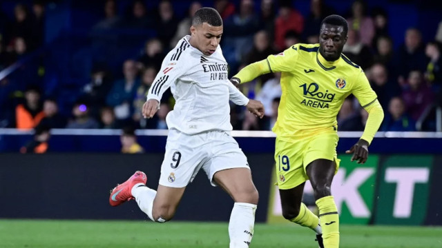 Real Madrid's Kylian Mbappe shoots next to Villarreal's Nicolas Pepe during Saturday’s LaLiga match at La Ceramica Stadium Photo: AFP