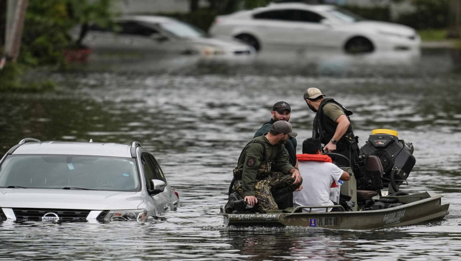 "A search and rescue team navigates rising waters, helping those stranded by the flooding caused by Hurricane Milton."