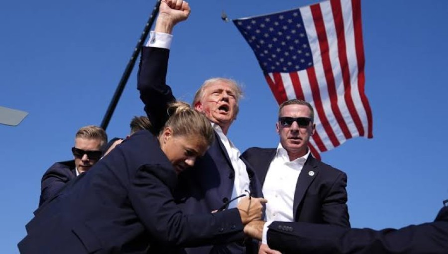 Republican presidential candidate former President Donald Trump is surrounded by U.S. Secret Service agents at a campaign rally.