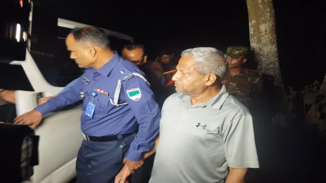 Former MP Salahuddin Miazi being taken into custody by law enforcement officials in Jessore after a student protest on Tuesday night.