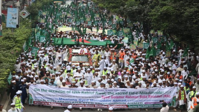 Devotees participate in a colorful procession through Dhaka streets to celebrate Eid-e-Milad-un-Nabi, led by Shahzada Syed Shahid Uddin Ahmad Maizbhandari and prominent Islamic scholars.