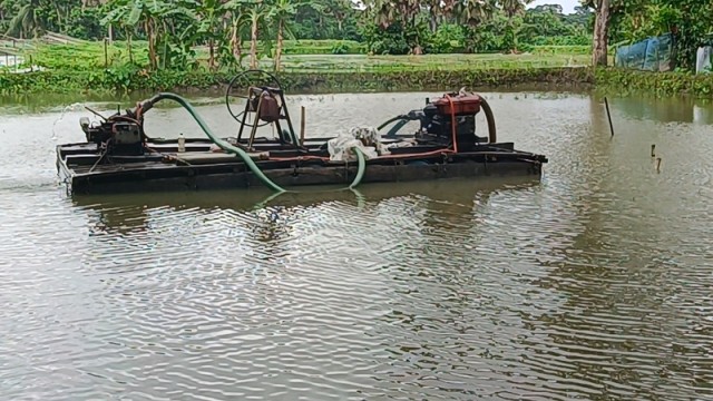 A local resident operates an illegal sand dredger in Barashia village, Chitalmari upazila, Bagerhat — causing environmental damage and threatening nearby homes and farmland.