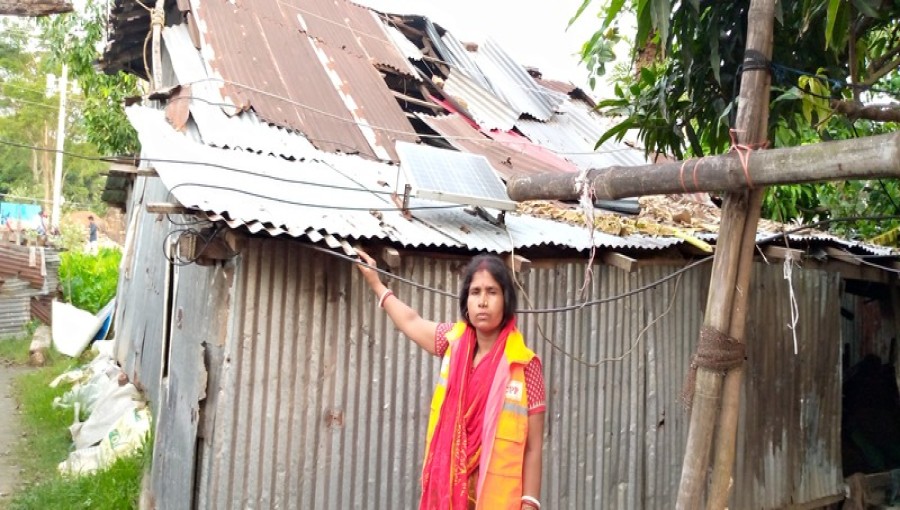Trishna Rani stands amidst the ruins of her home in Kalapara Municipality, Patuakhali, left devastated by Cyclone Remal. Photo: Voice7 News