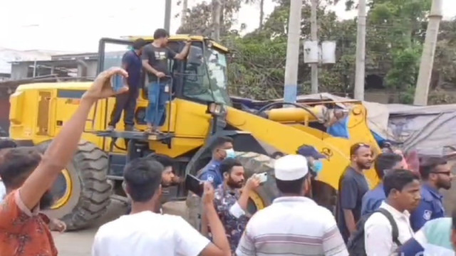 Police vehicles vandalized by encroachers during an eviction operation in Ashulia on March 23.