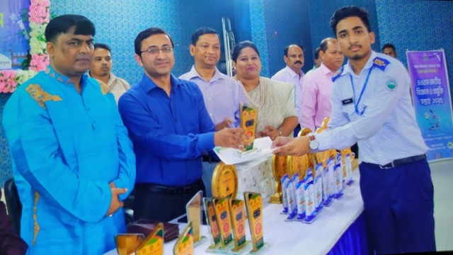 Arpan Dey proudly receives his award for outstanding SSC performance at Khagrachari Cantonment Public School and College. (Photo: V7N)