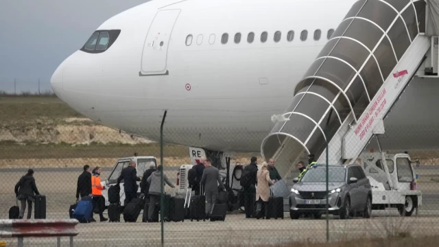 On Monday, December 25, 2023, in Vatry, eastern France, crew members board the aircraft that has been grounded by authorities. Following an extraordinary Christmas nightmare that saw almost 300 Indian