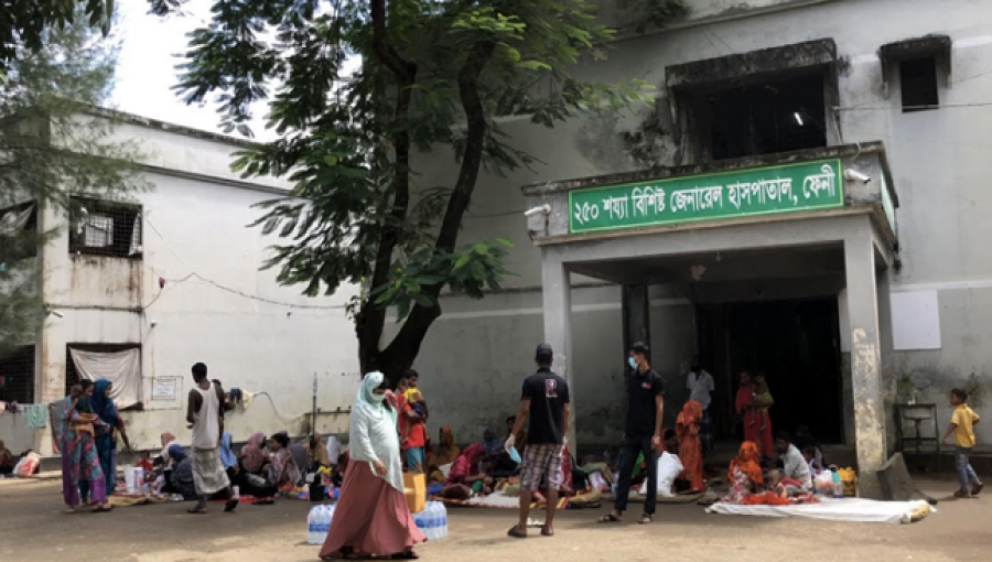 and their families crowd the Feni General Hospital, where the 18-bed diarrhea ward is inundated with 176 patients amid a surge of flood-related illnesses. Many are being treated on the floor or outside due to severe overcrowding.