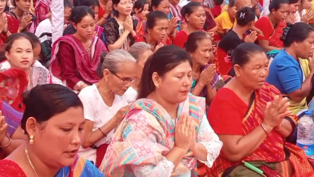 Devout women offer prayers with deep reverence during the 32nd Kathina Robe Offering Festival at Subalong Bana Vihara in Jurachhari, Rangamati.
