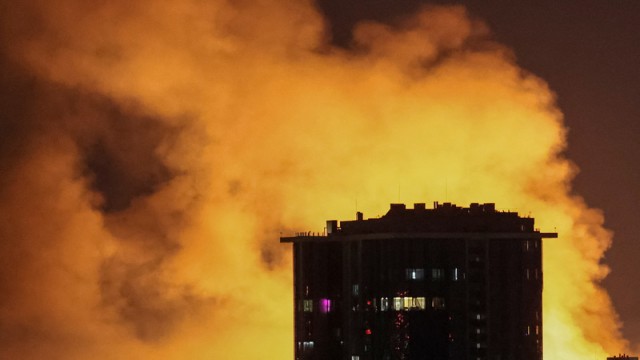 Flames engulf a high-rise residential building in central Kyiv following a massive overnight drone assault by Russian forces, highlighting the widespread destruction and the severe toll on civilian infrastructure.