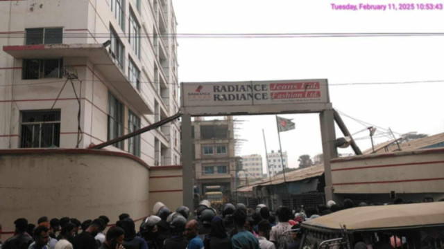 "Police recovering the body of a garment worker found hanging at a factory in Ashulia."