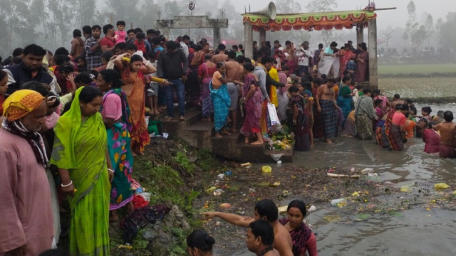 Devotees take a holy dip at Poati Bill during the Maghi Purnima celebration in Kalihati, Tangail.