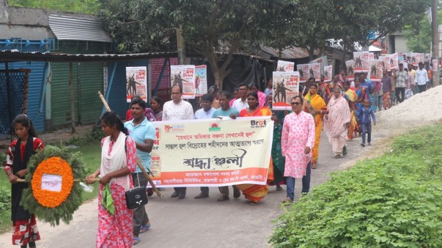 "Participants march through Kakonbazar in a colorful rally marking the 170th Santal Hul Day, organized by CCBVIO and local groups, before laying a wreath at the Shaheed Minar in Kakonhat Municipality. June 30, 2025." (Photo: V7N)