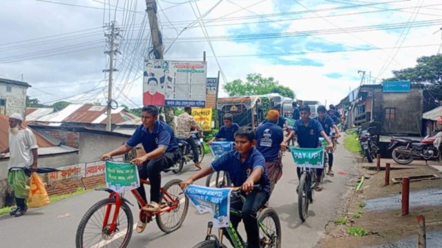Activists ride through Patharghata town calling for unconditional climate finance and justice for vulnerable coastal communities.