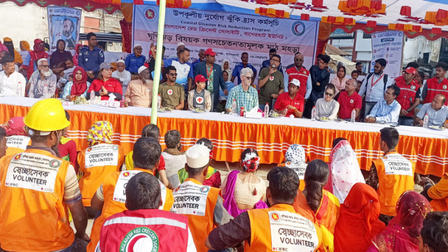 "A disaster preparedness drill on cyclone and emergency response, organized by the Bangladesh Red Crescent Society, being held at Panggaw MM Secondary School in Morelganj, Bagerhat, with participation from local and international officials."