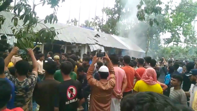 Local residents of Kayemkola village in Pabna destroying the shrine of a so-called pir, Delwar Hossain, on March 22, 2025, following allegations of immoral activities.