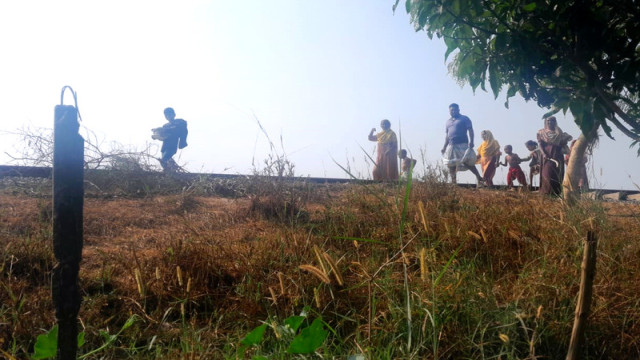 "Villagers from Tantiaband, Sathi, Pabna, step in to help stranded train passengers by providing food and water after the train's engine broke down on February 9."