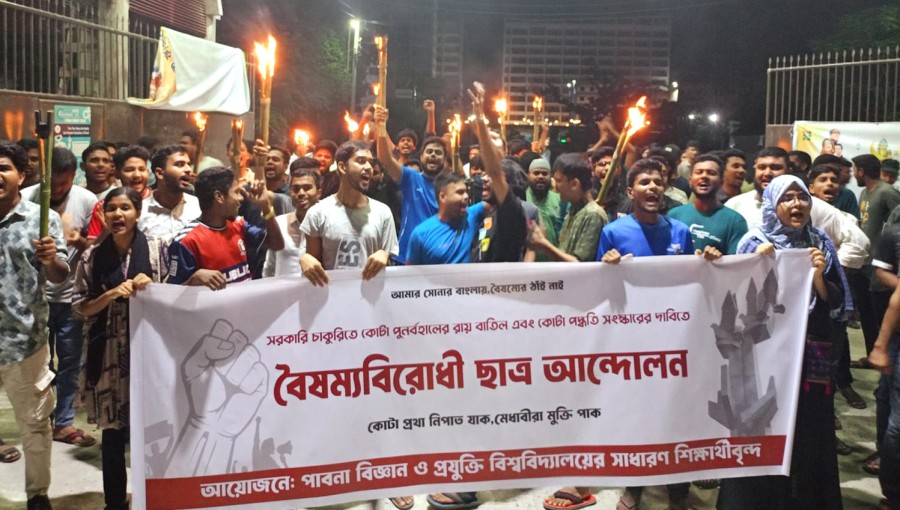 "Students chant anti-quota slogans during a sit-in protest at PUST's main gate following a torch procession." Photo: Voice7 News