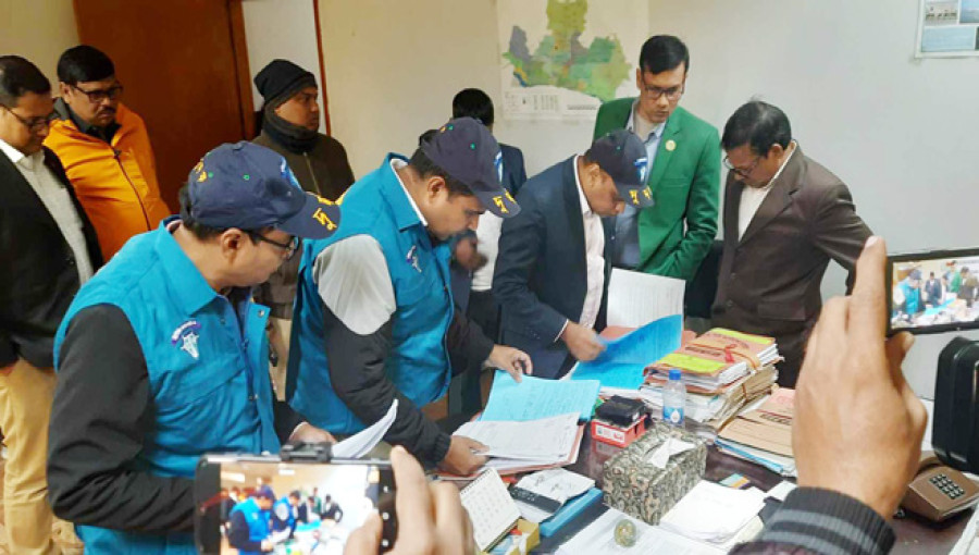 ACC team examining documents at Rajshahi City Corporation during the raid over alleged irregularities in the renovation of the city hall.