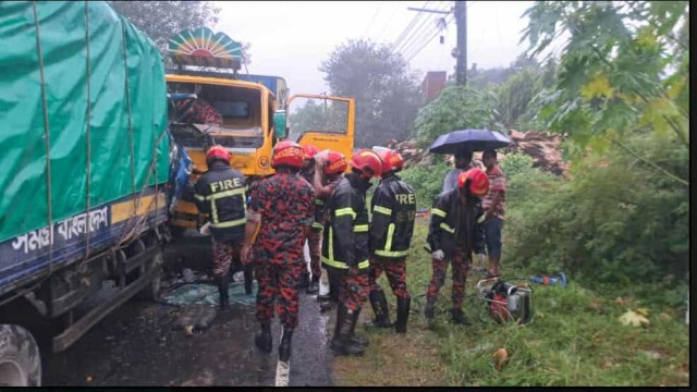 Fire service personnel recover the body of a truck driver and rescue three injured victims after a head-on collision between two trucks on the Ishwardi-Pabna highway in Pabna early on Thursday morning.