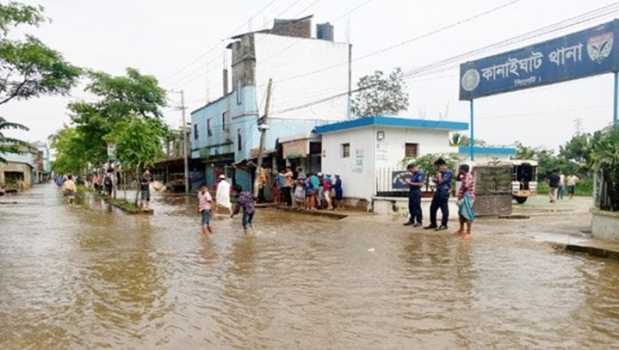 Residents of Sylhet navigating floodwaters as the situation shows signs of improvement, though water levels are receding slowly.