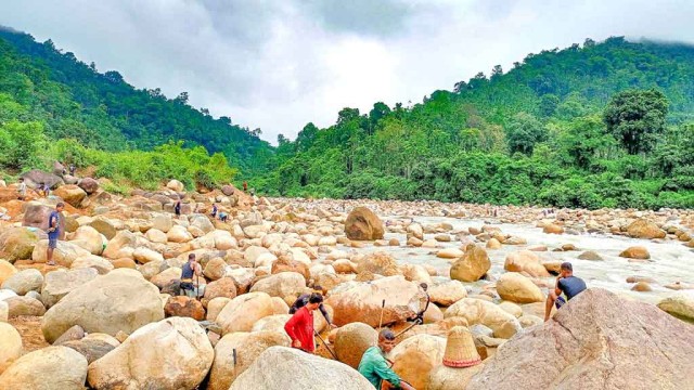 Locals walk through the eroded landscape of Sylhet’s Rangpani tourist site in Bangladesh, where unchecked stone extraction is threatening the area’s natural beauty and ecological balance.