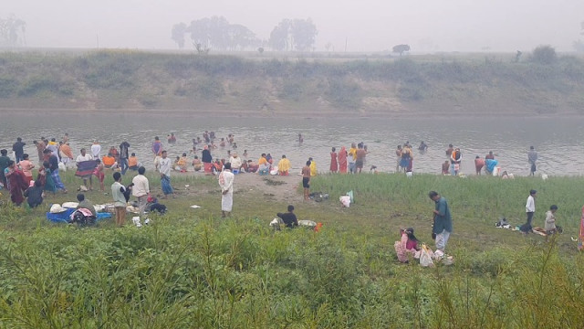 Devotees participate in the traditional "Dub-er Mela" in Syedampur, Tangail, where thousands gather to take part in the sacred bath to cleanse their sins, marking the occasion of Maghi Purnima.