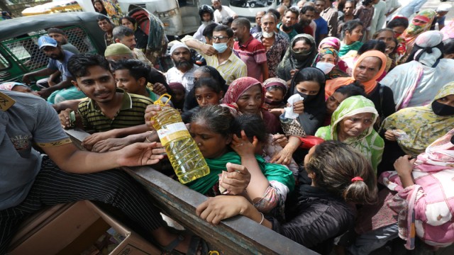Residents crowd around a TCB truck in Dhaka to buy essential goods at subsidized prices, as rising inflation drives daily necessities out of reach for many. Photo: A H Mintu-V7N