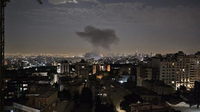 "Smoke rises over residential buildings in Tehran following an airstrike, as Israeli attacks continue across multiple Iranian cities. (Photo: Reuters)"