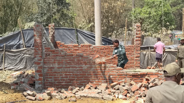 Forest officials carry out a demolition operation on illegally constructed buildings encroaching on protected forest land.