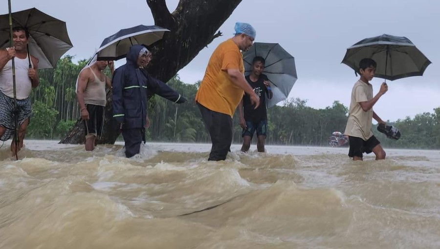 Residents of Ukhiya wade through floodwaters after heavy rains inundate 35 villages, trapping around 20,000 people. Damage to homes and infrastructure is widespread, with limited response from local authorities. Photo: Voice7 News