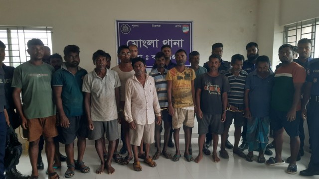 "Fourteen Indian fishermen, detained aboard the fishing trawler FB Parmita for illegally entering Bangladesh waters, are escorted by police at Mongla Police Station before being sent to Bagerhat jail — August 4, 2025. (V7N Photo)"