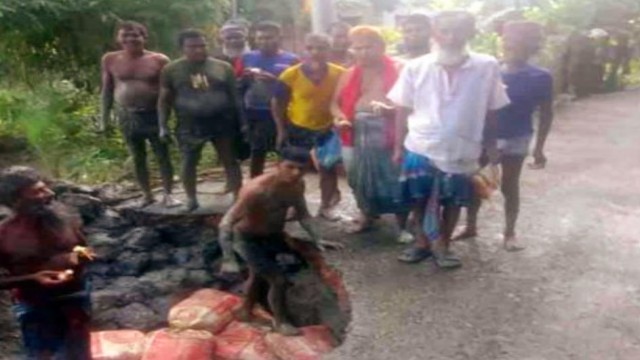 Local youths in Kathalia work together to repair a large pothole on the main road leading to the Upazila Health Complex, restoring temporary access for ambulances and residents amidst ongoing neglect by authorities.