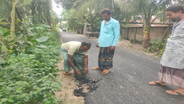 “Local residents inspect and shake the newly paved road in Durgapur, Rajshahi, as it shows signs of damage just days after completion.”