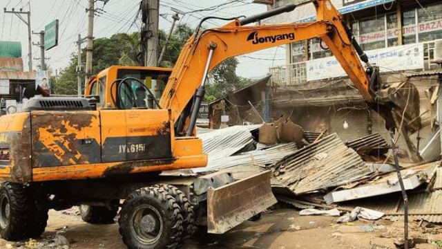 Police and local administration conduct an eviction drive, removing unauthorized shops and structures from government land in Sonargaon.