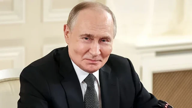 Photo of Vladimir Putin — A recent image of Putin speaking at the Saint Petersburg International Economic Forum, preferably at a podium or during the roundtable meeting with journalists.