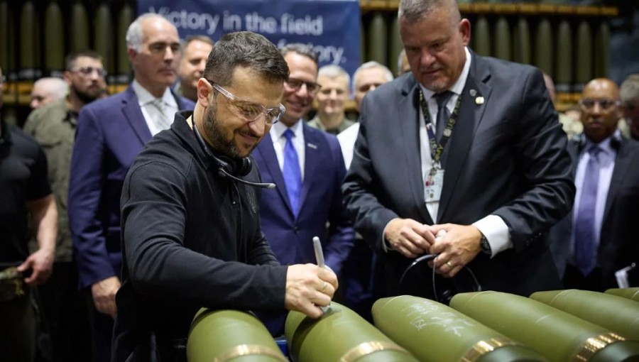 This handout photograph taken by the Ukrainian Presidential press service on September 22, 2024, shows the President of Ukraine Volodymyr Zelensky, signing shells during his visit at Scranton Army Ammunition Plant in Scranton, Pennsylvania.