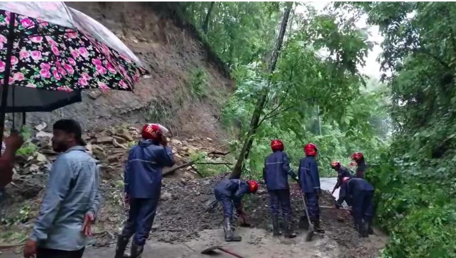 "Fire service workers clear landslide debris on Alutila Road, restoring traffic between Dhaka and Chittagong."