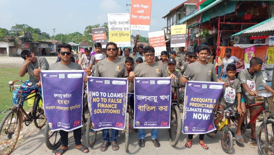 "Participants in Mongla’s climate rally ride bicycles, displaying anti-fossil fuel banners and placards, calling for 100% renewable energy financing and climate debt cancellation." Photo: V7N