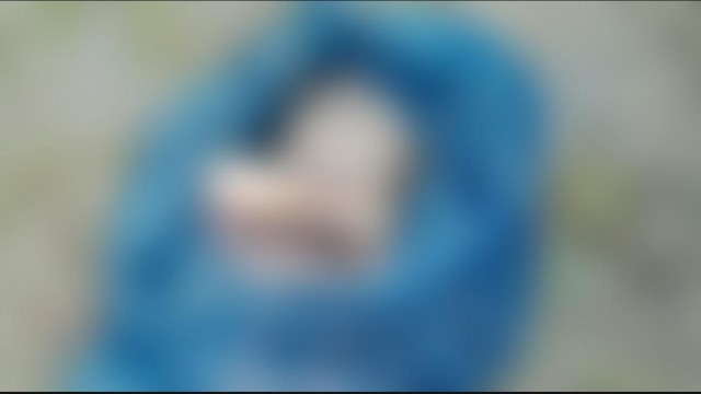 Police recover the body of a newborn wrapped in a sack from a pond in Mongla, following a 999 emergency call.