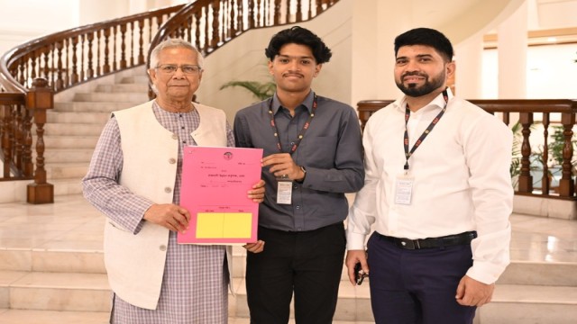 Chief Adviser Professor Muhammad Yunus hands over the long-delayed plot deed to Mahir Sarowar Megh, son of slain journalists Sagar Sarowar and Meherun Runi, at a ceremony in Dhaka on August 21, 2025. Photo: AH Mintu/V7N